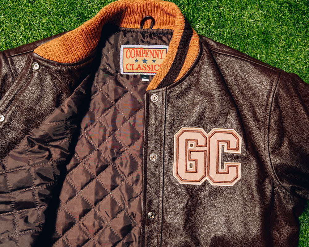 Brown and orange Good Compenny letterman jacket with GC lettering and striped collar